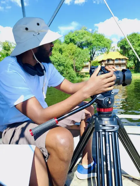 Operating a camera on a tripod from a boat on a river