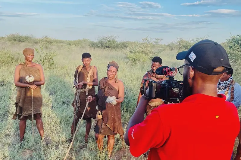 Filming a group in Kalahari grassland at golden hour